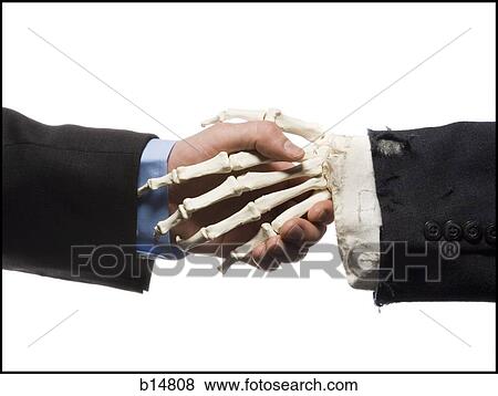 Businessman shaking hands with skeleton View Large Photo Image Stock Photo - Businessman shaking hands with skeleton. Fotosearch
