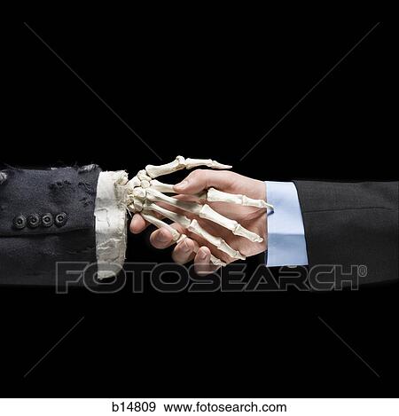 Businessman shaking hands with skeleton View Large Photo Image Stock Photo - Businessman shaking hands with skeleton. Fotosearch