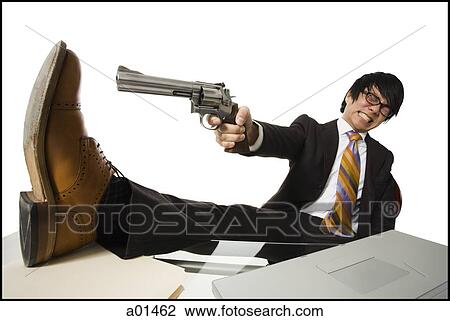 Businessman sitting at desk pointing shotgun at foot View Large Photo Image Stock Image - Businessman sitting at desk pointing shotgun at foot. Fotosearch