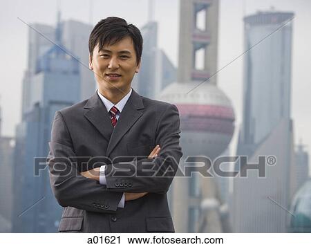 Businessman standing with arms crossed outdoors View Large Photo Image Stock Image - Businessman standing with arms crossed outdoors. Fotosearch