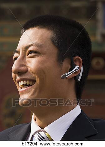 Businessman with headset smiling outdoors View Large Photo Image Picture - Businessman with headset smiling outdoors. Fotosearch