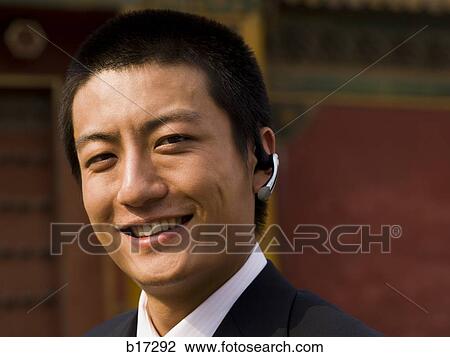 Businessman with headset smiling outdoors View Large Photo Image Stock Image - Businessman with headset smiling outdoors. Fotosearch