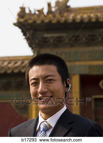 Businessman with headset smiling outdoors View Large Photo Image Stock Image - Businessman with headset smiling outdoors. Fotosearch