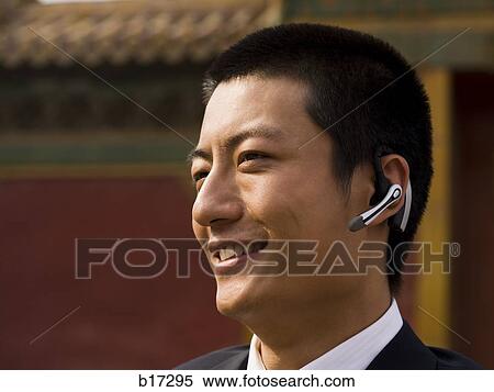 Businessman with headset smiling outdoors View Large Photo Image Stock Photography - Businessman with headset smiling outdoors. Fotosearch