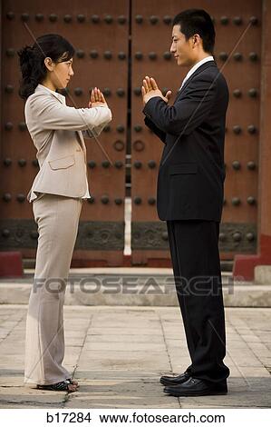 Businesswoman and man facing each other in greeting outdoors View Large Photo Image Picture - Businesswoman and man facing each other in greeting outdoors. Fotosearch