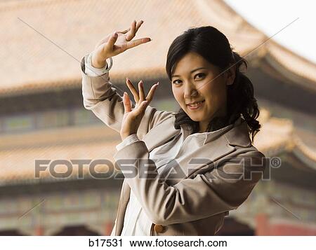 Businesswoman doing tai chi outdoors smiling View Large Photo Image Stock Image - Businesswoman doing tai chi outdoors smiling. Fotosearch