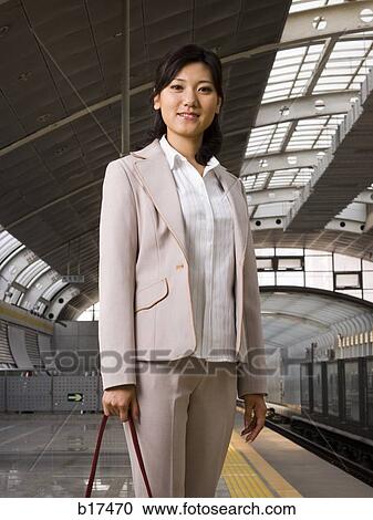Businesswoman on subway platform smiling View Large Photo Image Stock Image - Businesswoman on subway platform smiling. Fotosearch
