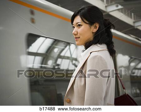 Businesswoman on subway platform smiling View Large Photo Image Stock Photo - Businesswoman on subway platform smiling. Fotosearch