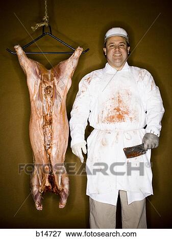 Stock Photo - Butcher with hanging carcass and knife smiling. Fotosearch