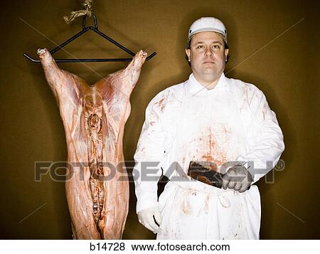 Stock Photo - Butcher with hanging carcass and knife. Fotosearch