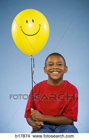 Picture - Child holding a balloon.. Fotosearch