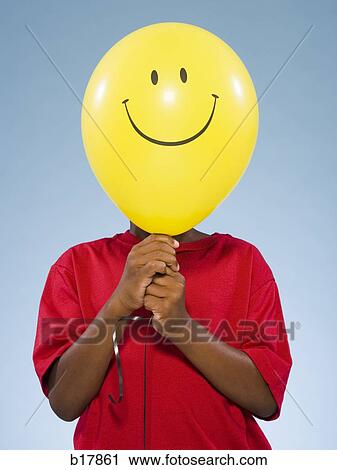 Child holding a balloon. View Large Photo Image Stock Image - Child holding a balloon.. Fotosearch