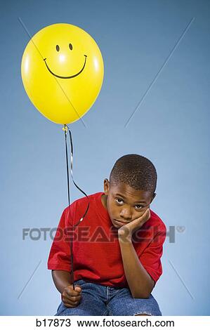 Child holding a balloon. View Large Photo Image Stock Image - Child holding a balloon.. Fotosearch