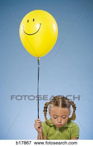 Stock Photo - Child holding a balloon.. Fotosearch