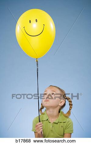 Child holding a balloon. View Large Photo Image Stock Photo - Child holding a balloon.. Fotosearch
