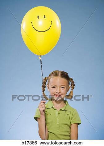 Child holding a balloon. View Large Photo Image Stock Photograph - Child holding a balloon.. Fotosearch