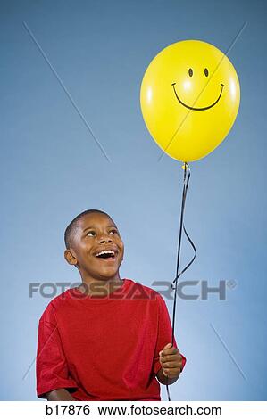 Child holding a balloon. View Large Photo Image Stock Photograph - Child holding a balloon.. Fotosearch