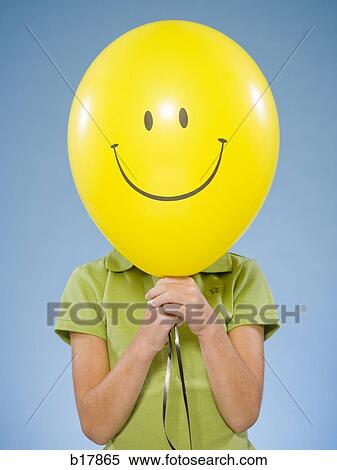 Stock Photography - Child holding a balloon.. Fotosearch