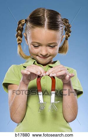 Stock Image - Child holding a magnet.. Fotosearch
