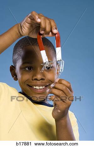 Child holding a magnet. View Large Photo Image Stock Image - Child holding a magnet.. Fotosearch