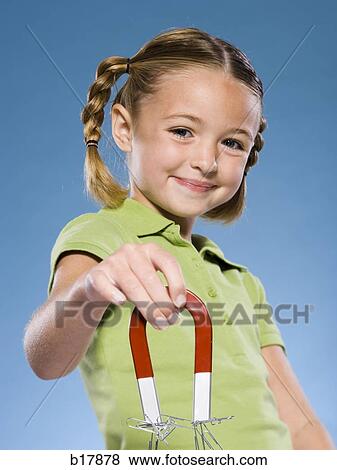 Stock Photo - Child holding a magnet.. Fotosearch