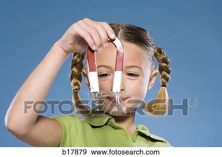 Child holding a magnet. View Large Photo Image Stock Photo - Child holding a magnet.. Fotosearch