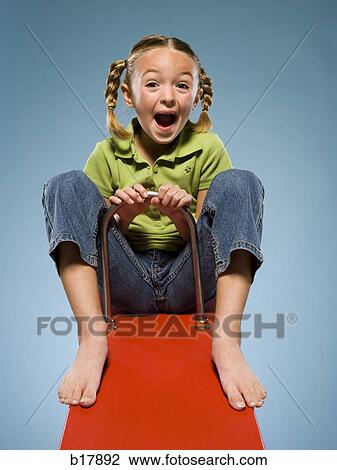 Child riding on a see saw. View Large Photo Image Stock Image - Child riding on a see saw.. Fotosearch