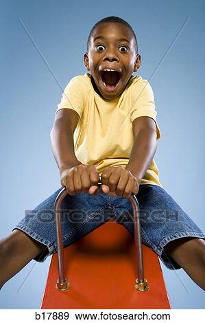 Child riding on a see saw. View Large Photo Image Stock Photo - Child riding on a see saw.. Fotosearch