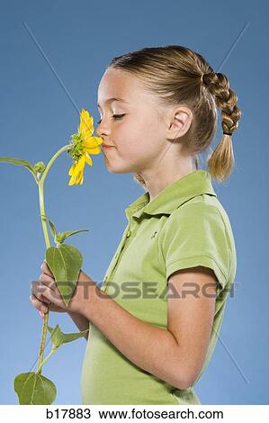 Child smelling a flower. View Large Photo Image Stock Image - Child smelling a flower.. Fotosearch