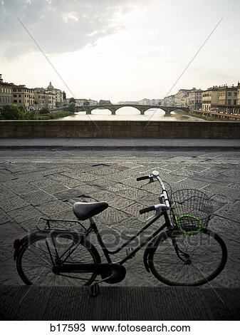 City skyline on waterfront with bridge and bicycle View Large Photo Image Stock Image - City skyline on waterfront with bridge and bicycle. Fotosearch