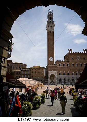 Clock tower in public square with people and blue sky View Large Photo Image Stock Photo - Clock tower in public square with people and blue sky. Fotosearch