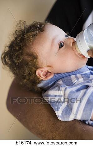 Picture - Close-up of baby boy drinking from bottle. Fotosearch