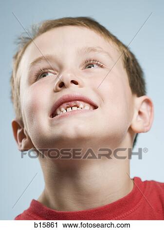 Stock Image - Close-up of boy smiling with missing teeth. Fotosearch