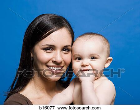 Close-up of woman and baby smiling View Large Photo Image Stock Photo - Close-up of woman and baby smiling. Fotosearch