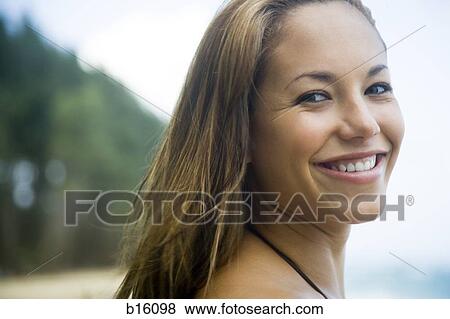 Close-up of woman smiling outdoors View Large Photo Image Stock Photo - Close-up of woman smiling outdoors. Fotosearch
