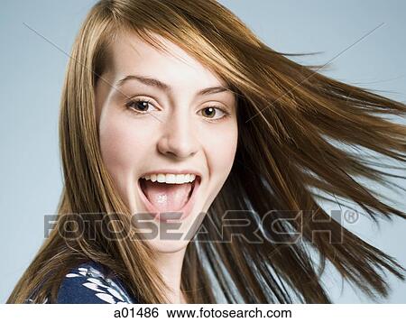 Close-up of woman smiling with tossed hair View Large Photo Image Stock Photograph - Close-up of woman smiling with tossed hair. Fotosearch