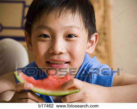 Closeup of boy eating watermelon View Large Photo Image Stock Image - Closeup of boy eating watermelon. Fotosearch