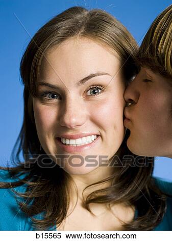 Closeup of boy kissing girl on cheek View Large Photo Image Stock Photography - Closeup of boy kissing girl on cheek. Fotosearch