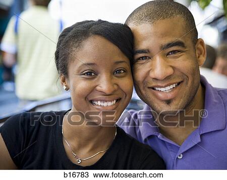 Stock Image - Closeup of couple smiling outdoors. Fotosearch