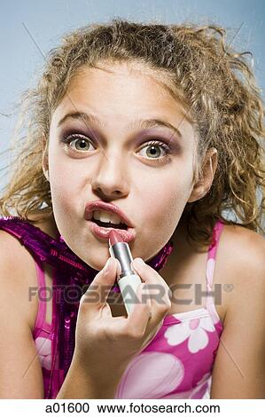 Closeup of girl applying lipstick View Large Photo Image Stock Image - Closeup of girl applying lipstick. Fotosearch