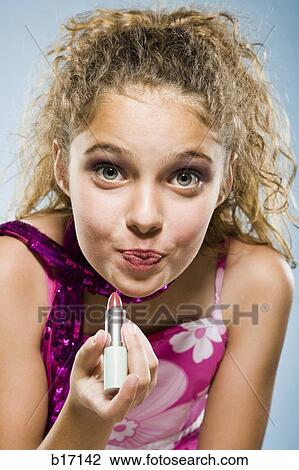 Closeup of girl applying lipstick View Large Photo Image Stock Image - Closeup of girl applying lipstick. Fotosearch