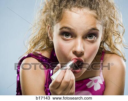 Closeup of girl applying lipstick View Large Photo Image Stock Image - Closeup of girl applying lipstick. Fotosearch
