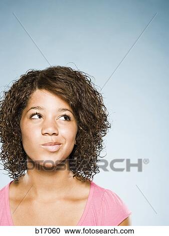 Stock Image - Closeup of girl thinking. Fotosearch