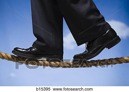 Closeup of male feet in dress shoes walking on rope outdoors View Large Photo Image Stock Photography - Closeup of male feet in dress shoes walking on rope outdoors. Fotosearch