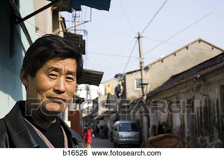 Stock Photograph - Closeup of man outdoors on street in village. Fotosearch