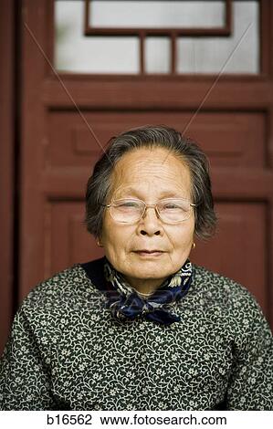 Closeup of mature woman with eyeglasses sitting View Large Photo Image Stock Image - Closeup of mature woman with eyeglasses sitting. Fotosearch