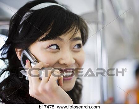 Closeup of teenage girl talking on cell phone smiling View Large Photo Image Stock Photography - Closeup of teenage girl talking on cell phone smiling. Fotosearch