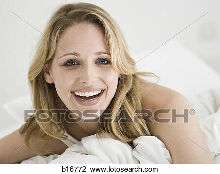 Closeup of woman in bed smiling View Large Photo Image Stock Image - Closeup of woman in bed smiling. Fotosearch