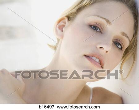 Closeup of woman leaning head on wall View Large Photo Image Stock Photo - Closeup of woman leaning head on wall. Fotosearch
