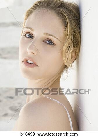 Closeup of woman leaning head on wall View Large Photo Image Stock Photo - Closeup of woman leaning head on wall. Fotosearch